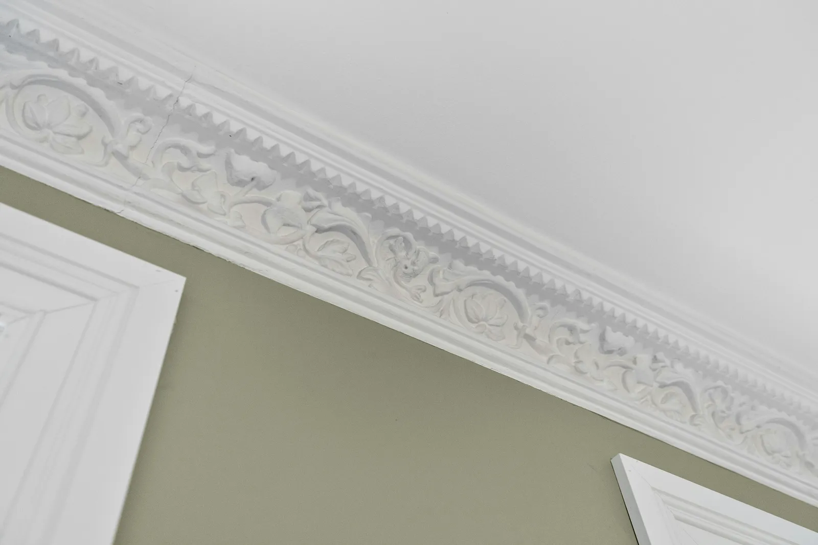 Decorative plaster coving fitted along a ceiling edge